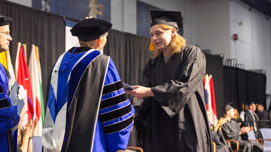 Man receiving diploma