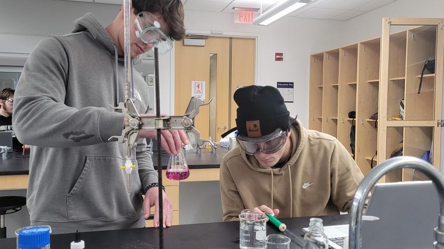 Honors chemistry students conduct an experiment on the hardness levels of campus water samples