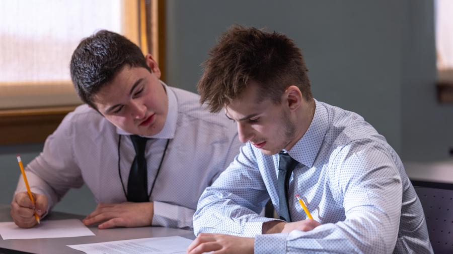 Two teens at desk