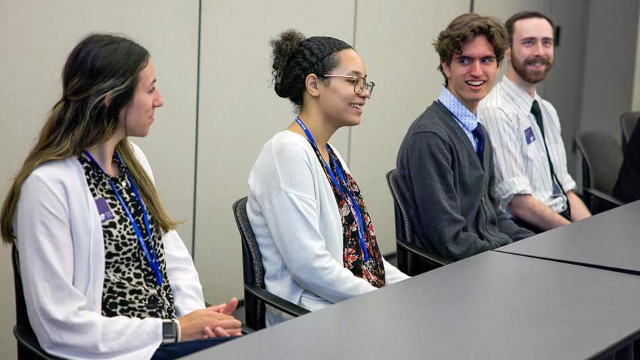 Four students sitting at table