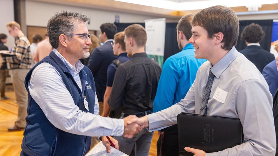 Students talk with employer recruiters at a career conference