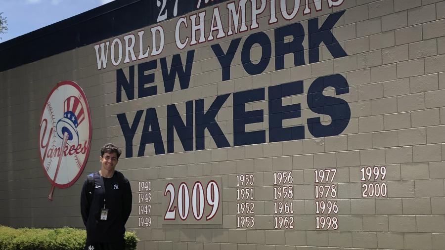 Man in front of New York Yankees sign