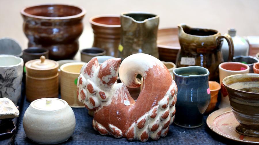 A table of ceramics at an art sale
