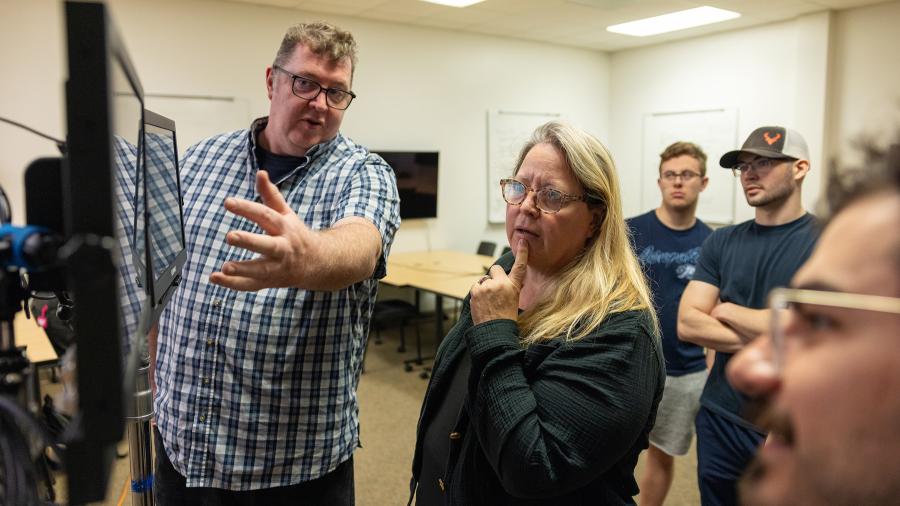 Two people look at monitor