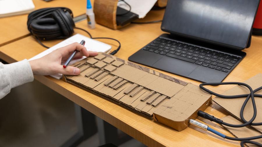 A cardboard prototype of a keyboard for a music creating machine.