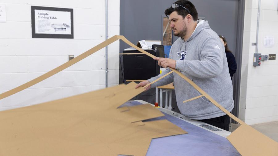 Man cutting cardboard