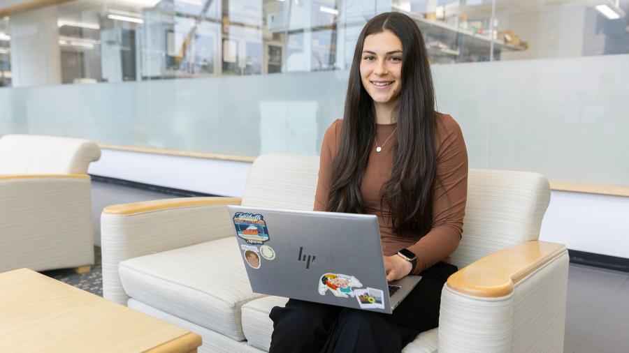 Woman sits with laptop