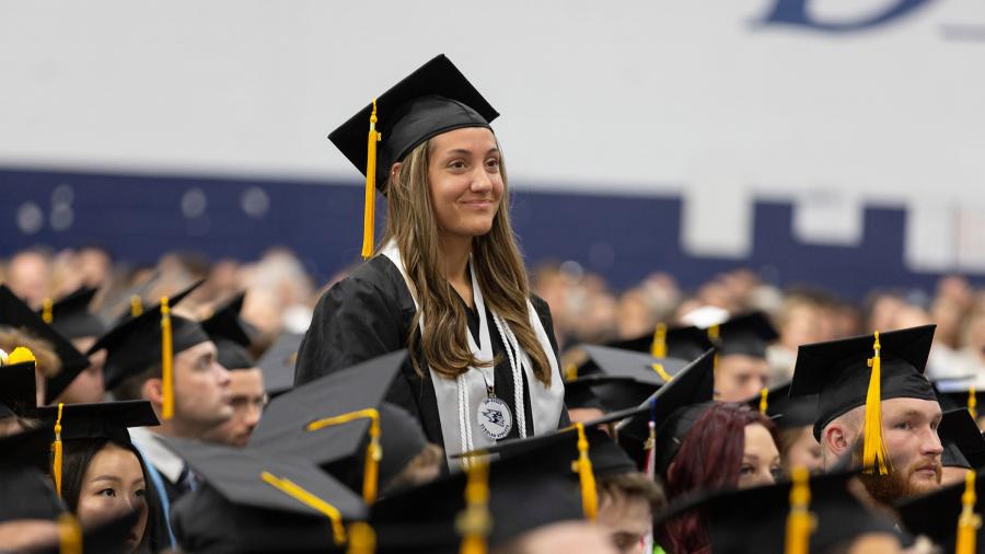 Woman stands at commencement