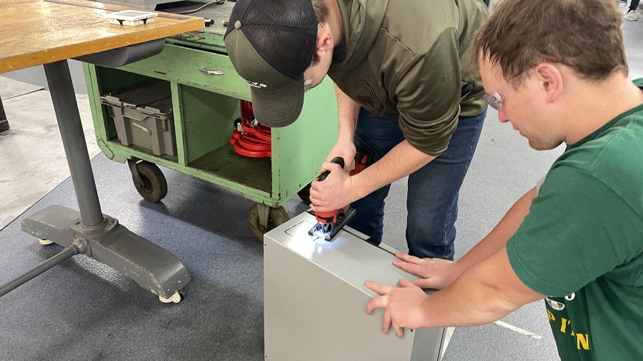 Students work on electrical box