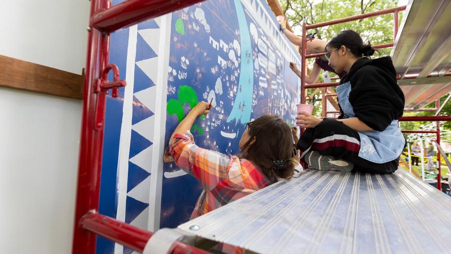 Volunteers paint mural