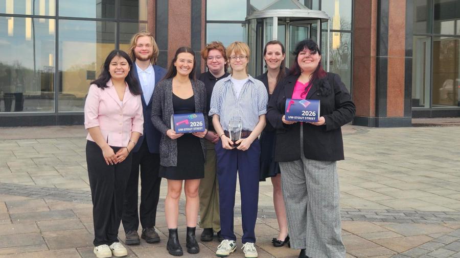 Sam Mireles-Melgarejo, Theodore Cerny, Becky Gaspord, Red Moser, Mallory Jakubiak, advisor Bethany Wheeler and Ariel Kissel, pose in front of the Konica Minolta building with the TAGA Student’s Choice Award.