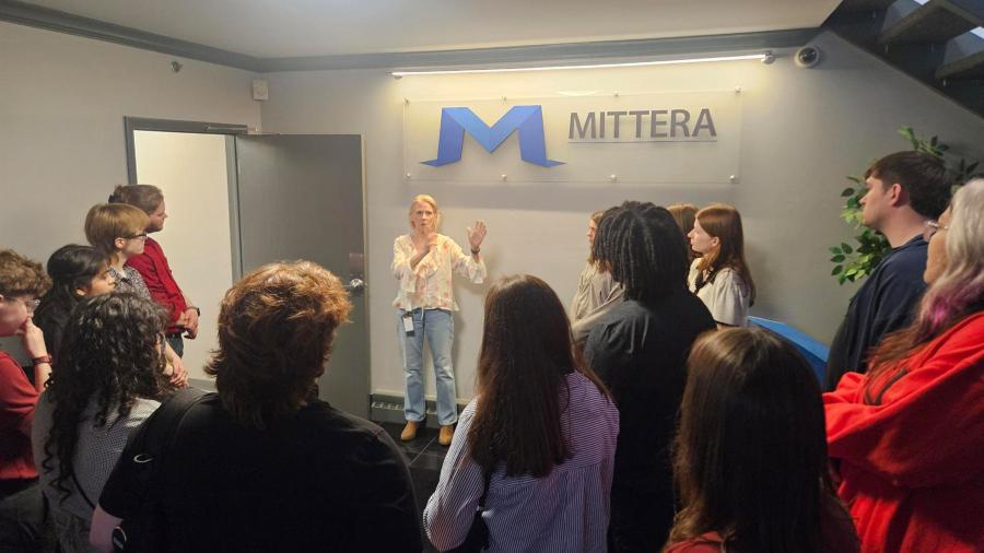 A group of students tours a printing company.