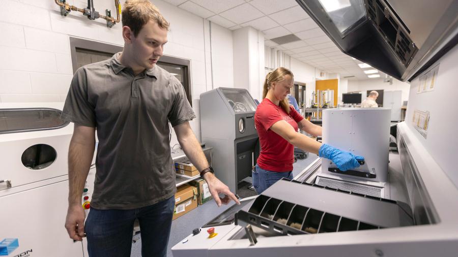 Two people with 3D printer