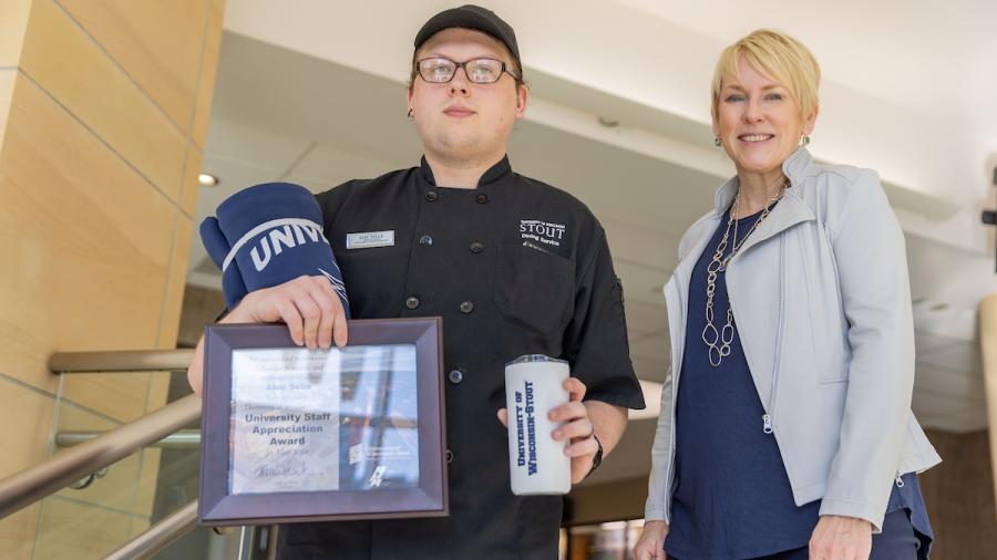 Two people with award