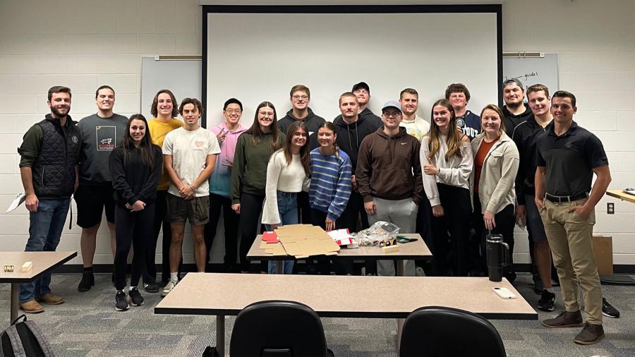 Max Marsh, an alum and senior designer at Green Bay Packaging, with a group of Stout students