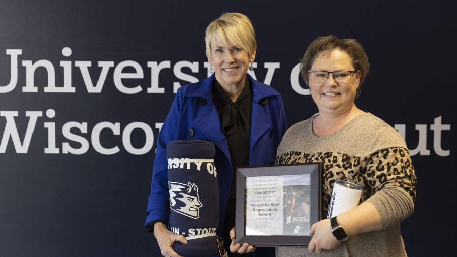 Two women holding award