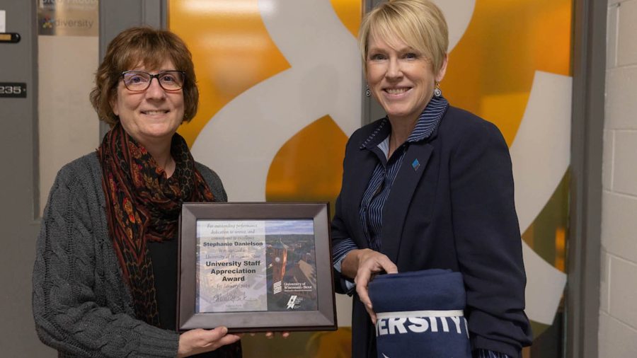 Two women pose with award