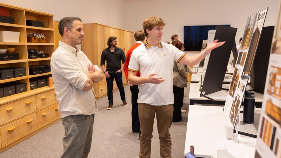Two men look at display boards