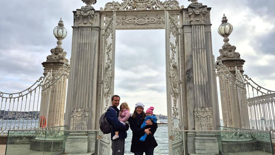 Family of four in front of ornate gate
