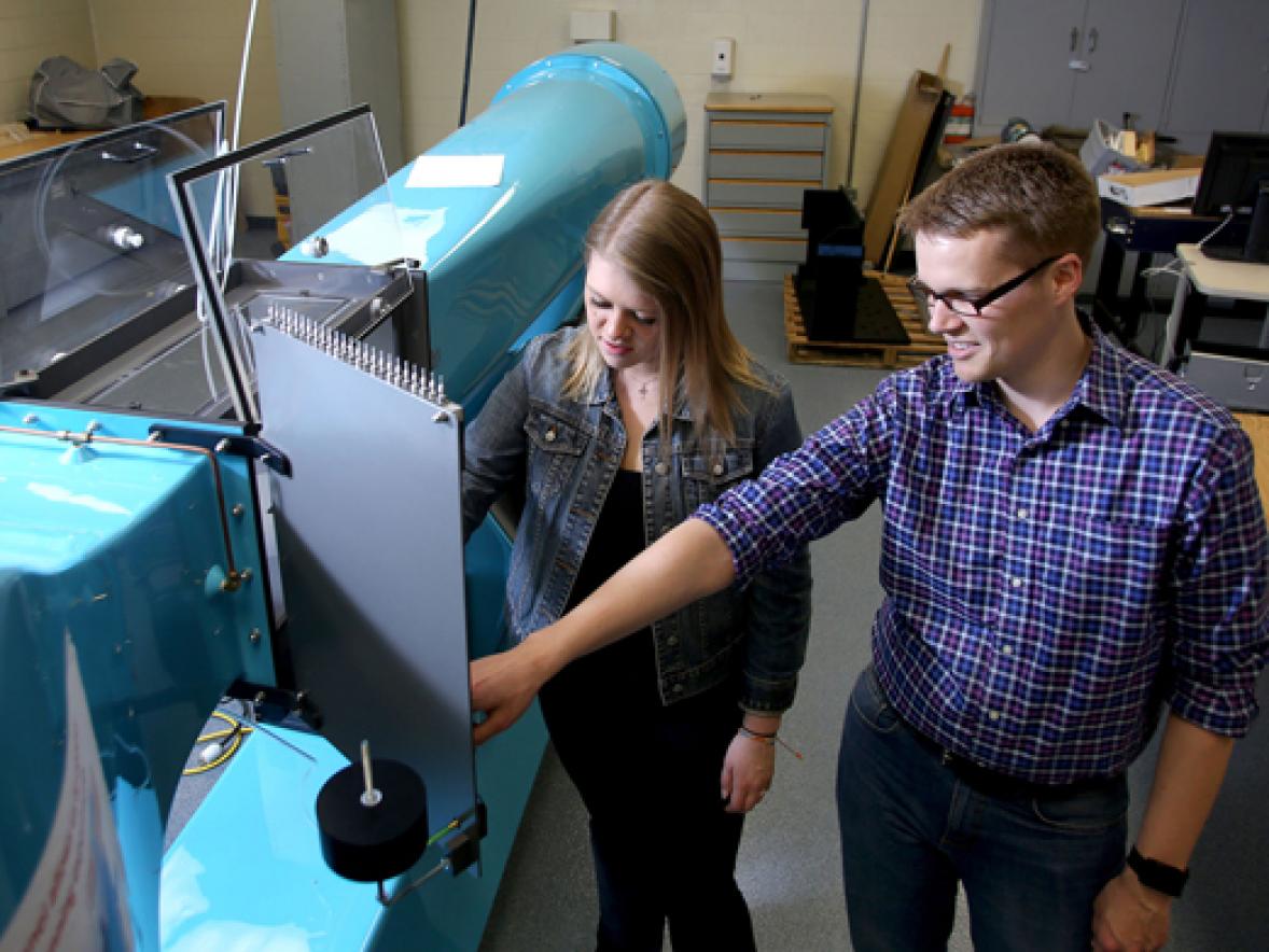 Associate Professor Devin Berg works with student Sarah Dillon in a manufacturing engineering lab in Fryklund Hall.