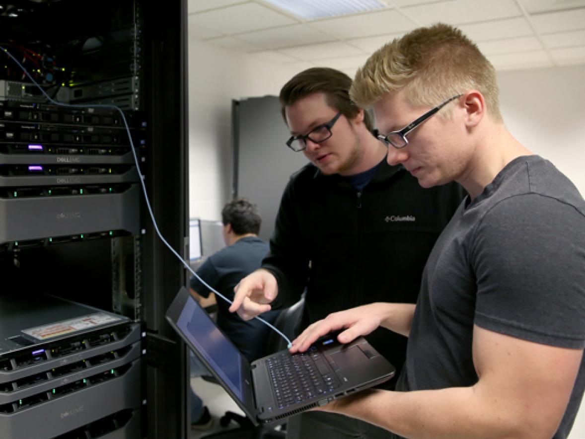 UW-Stout students Pierce Lannue, left, and Stephen Felton work in a computer networking and information technology lab in October in Fryklund Hall. UW-Stout has been named a national Center of Academic Excellence in Cyber Defense.