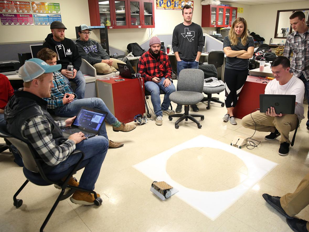 UW-Stout mechatronics students compete their suomo bots during a recent class. Students built and programmed and then competed in a 3-foot diameter circle. / UW-Stout photos by Brett T. Roseman