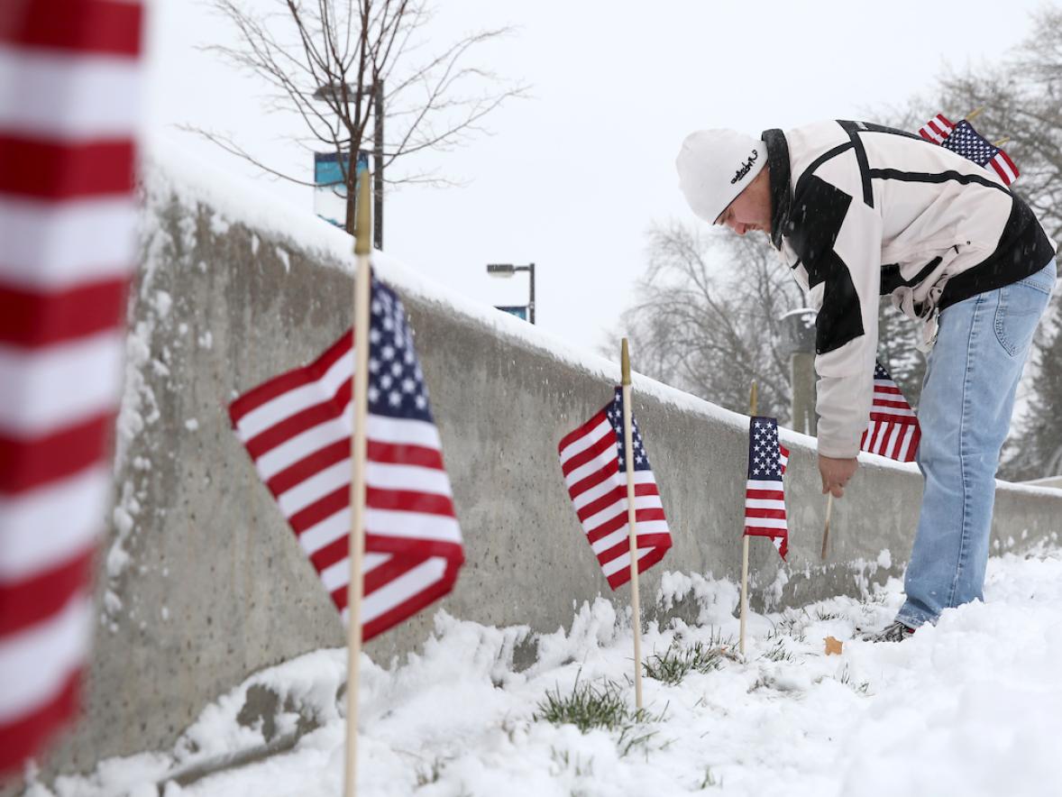 Pictured is Ben Kerr, of the UW-Stout Vets Club, posting American flags in the amphitheater at the Memorial Student Center early in the morning on Veterans Day.
