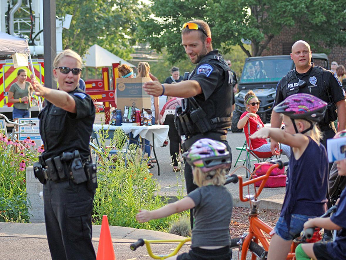 Healthier officers help keep the community safe. Menomonie police officers taught bicycle safety at a National Night Out event.