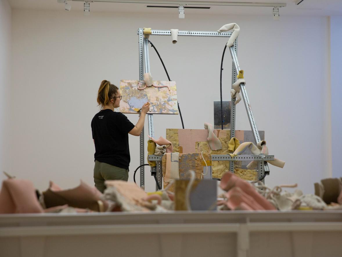 Emily Gordon, a Student Artist-in-Residence, prepares her exhibit at Furlong Gallery.