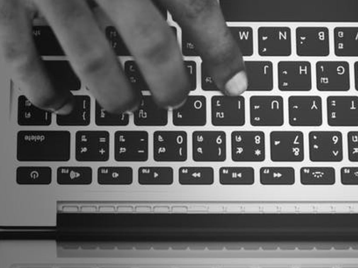 hand typing on a keyboard