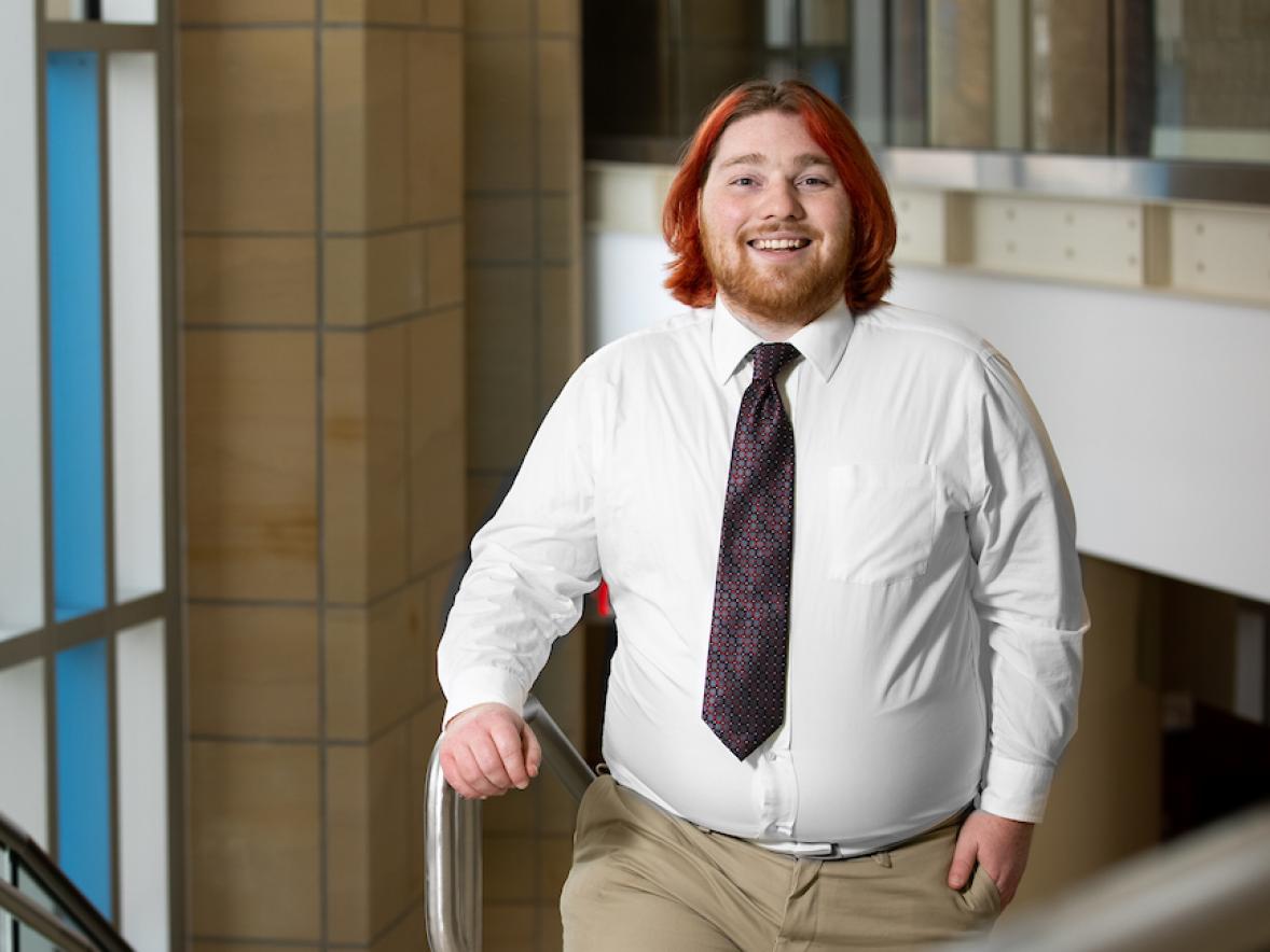 Zach Porter, entertainment design graduate, in the grand stairwell at Memorial Student Center.