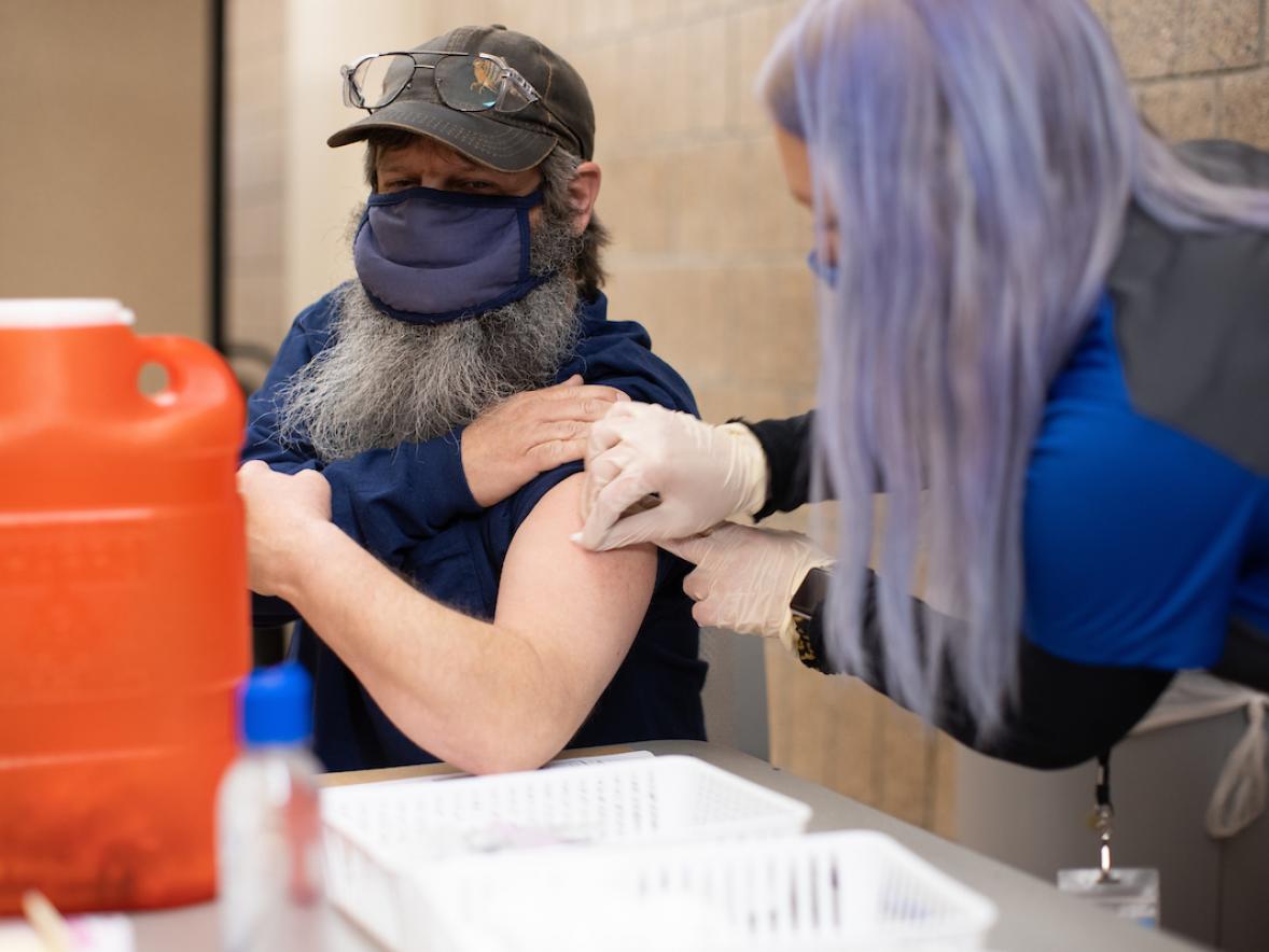 Kirk Miller, facilities repair worker advanced, receives his COVID-19 vaccination.