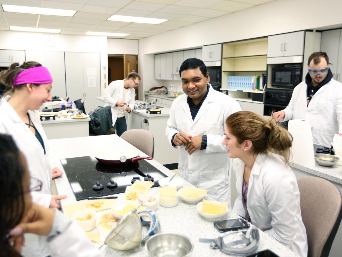 Assistant Professor Pranabendu Mitra, center, teaching a food science class lab in 2017.