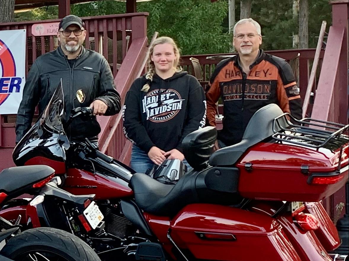 Emily Norgord, a junior this fall at UW-Stout, takes a break from a motorcycle ride with two co-workers from Harley-Davidson, Darin Mrachek, left, and Dennis Deitz.