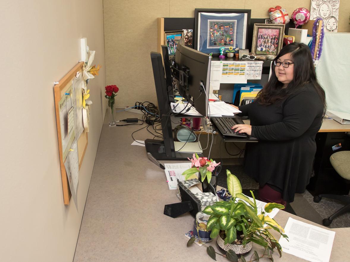 Joua Lor in a 2017 photo working at her UW-Stout Human Resources office.