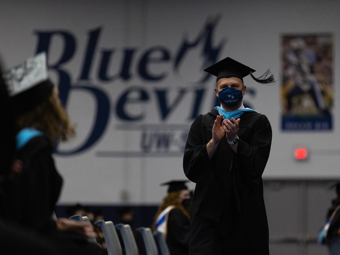 A graduate celebrates during the spring 2021 commencement at UW-Stout.