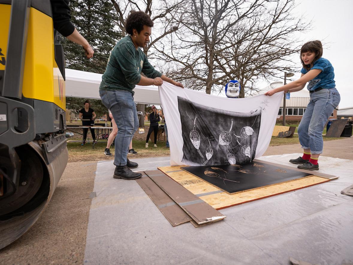 Revealing a print after being pressed.