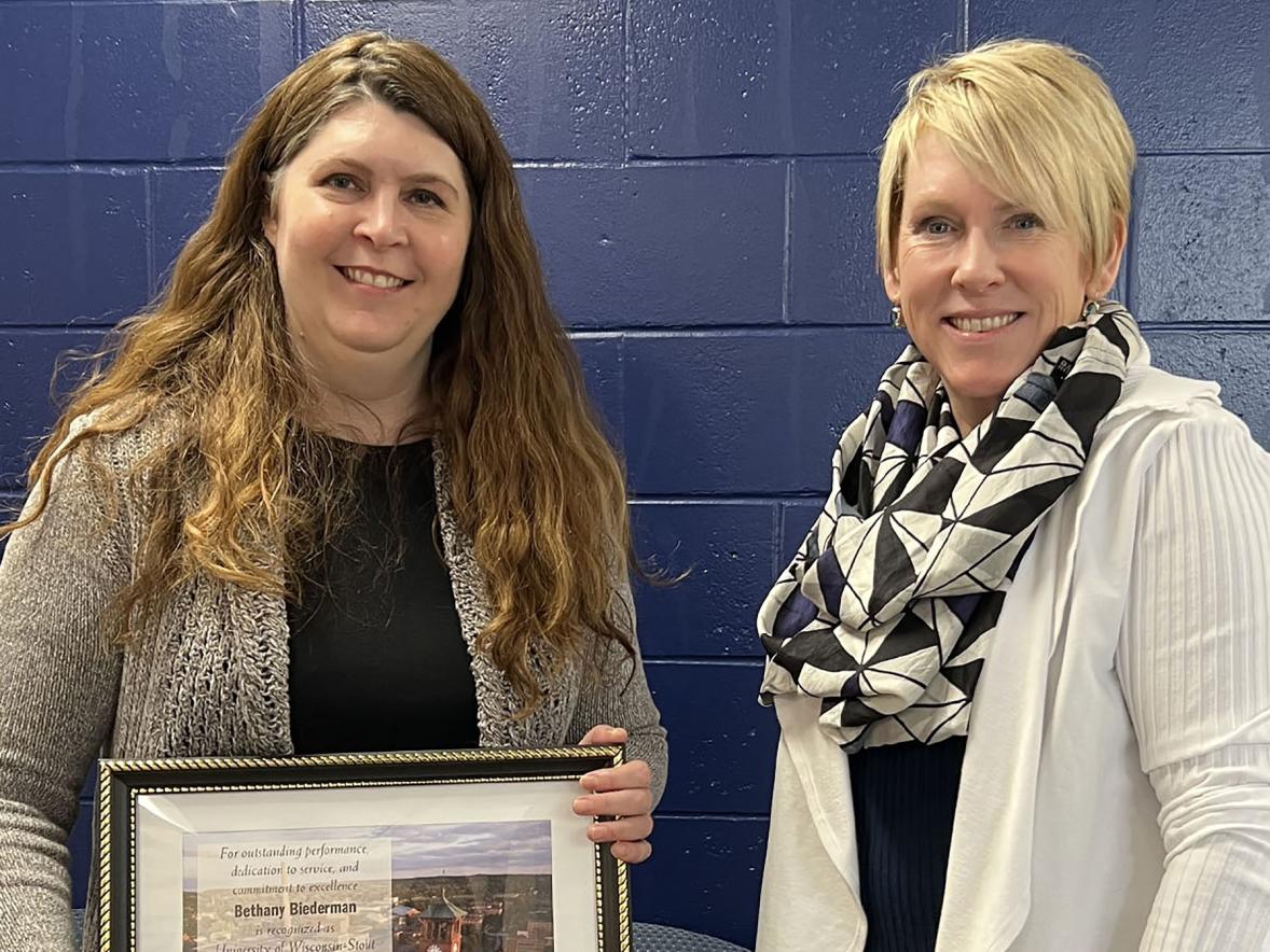 Beth Biederman, left, receives the February University Staff Employee Appreciation award from Chancellor Katherine Frank.