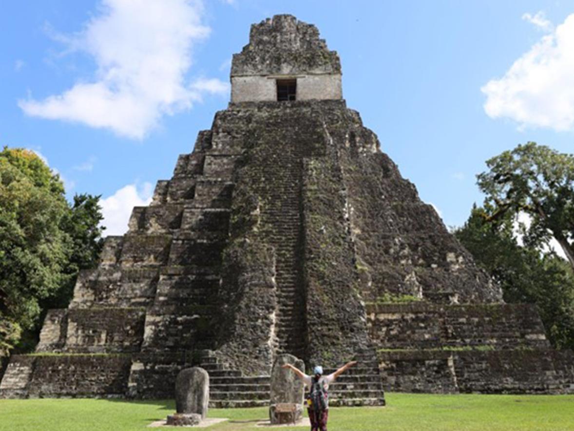 Conservation biology student Paige Letter at the base of a Mayan temple ruin. Photo by Paige Letter.
