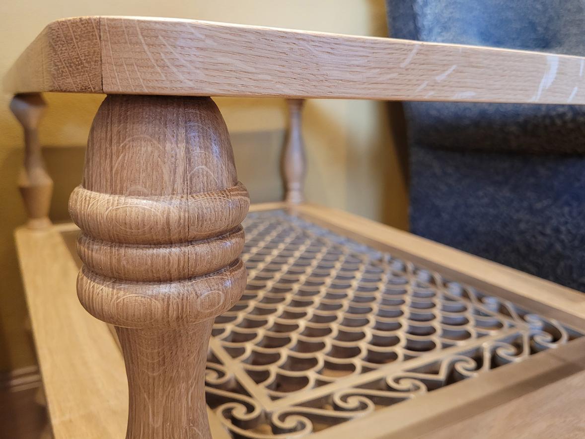 A close-up of a hand-turned white oak table leg