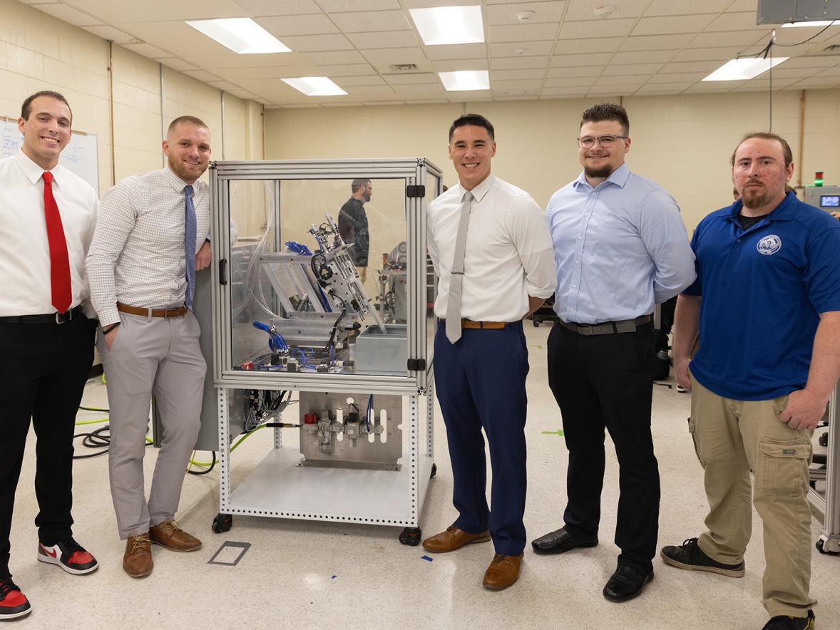 The nVent hinge demo team gathered around their design, included from left Caleb Rathje, Mack Klafter, Gervase Thompson, Evan Zaves and Andrew Hoeft.