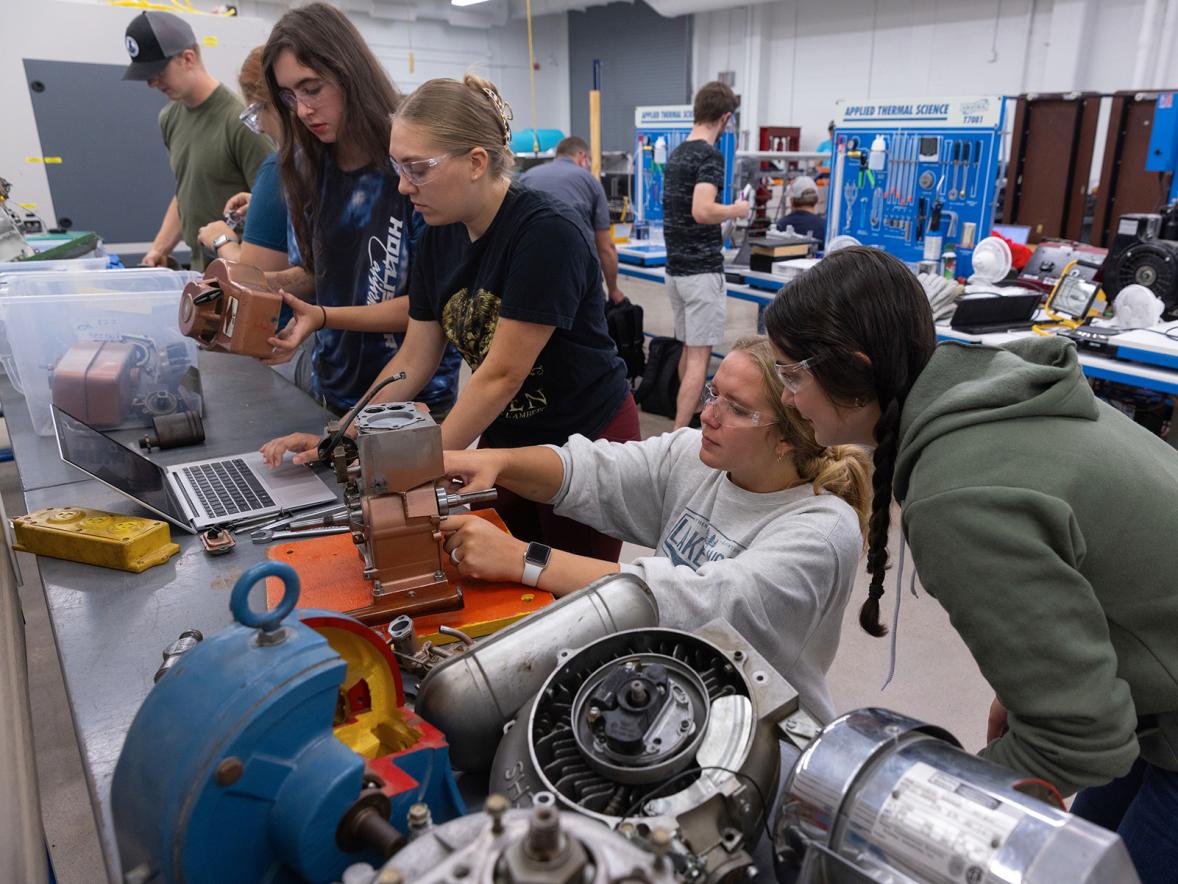 Mechanical engineering students work on an engine project in the renovated Engineering Technology Research and Development Lab.