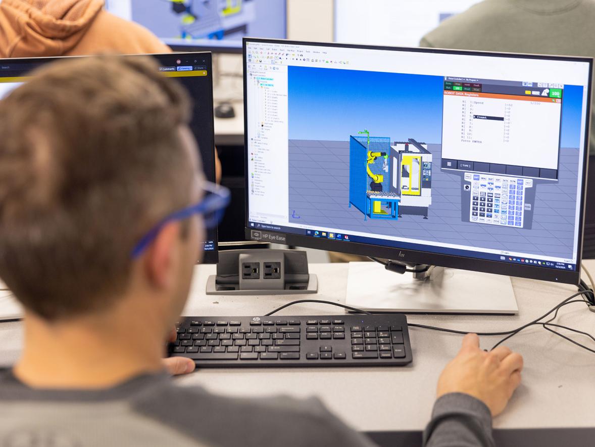 An engineering student looks at a computer screen.