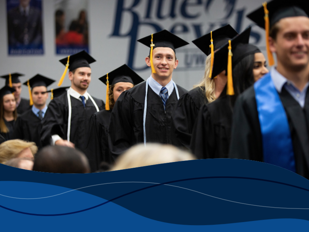 Graduates walk at commencement with text over the top stating "The Economic Value of UW-Stout" 