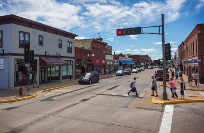 Pedestrians walk past local shops on Main Street in Menomonie, Wisconsin.