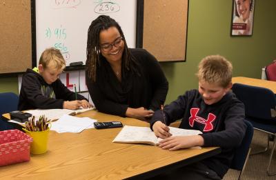 Courtney Jones Holm, an Education Graduate student at UW-Stout, teaches math to brothers Noah and Gabriel.