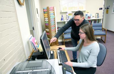 Advisor Jamie Arenz works with a student at the Advisement Center Tuesday, December 12, 2017.