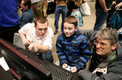 A UW-Stout student, left, explains how his game works at the game expo Wednesday, Dec. 13, in the Memorial Student Center. About 500 people tried games created by game design and development majors.
