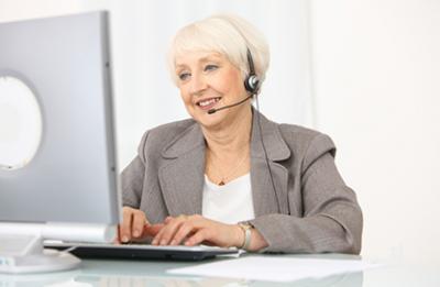 Photo of business woman working on a computer.