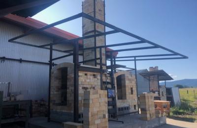 Two kilns sharing an 18-foot chimney built by Carter Pasma at Montana State University.